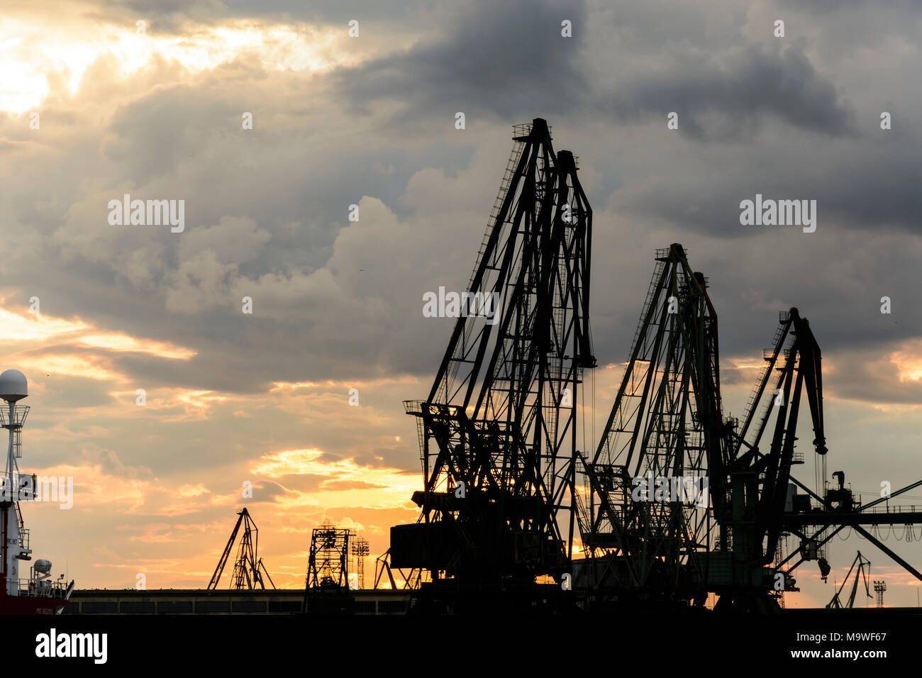 Construction cranes against evening hi-res stock photography and images ...