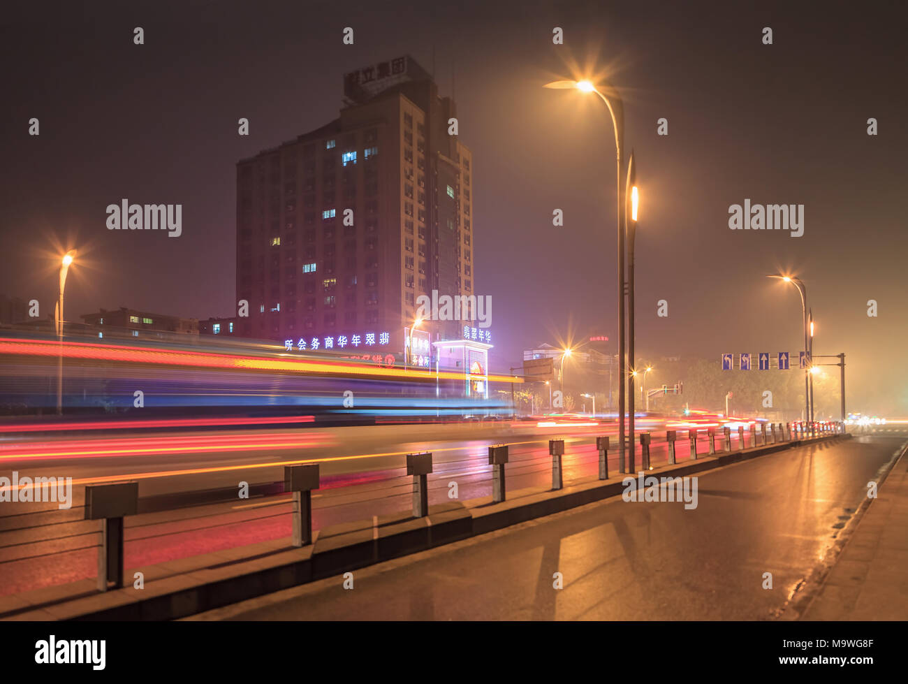 NANJING-MAY 24, 2014. Night scene with apartment building and traffic in motion blur. Nanjing is located in east of China in Yangtze River delta. Stock Photo