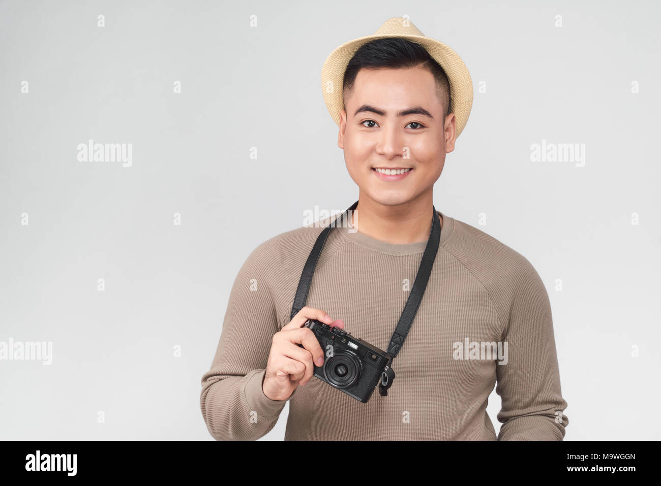 Asian young male backpacker take a picture Stock Photo