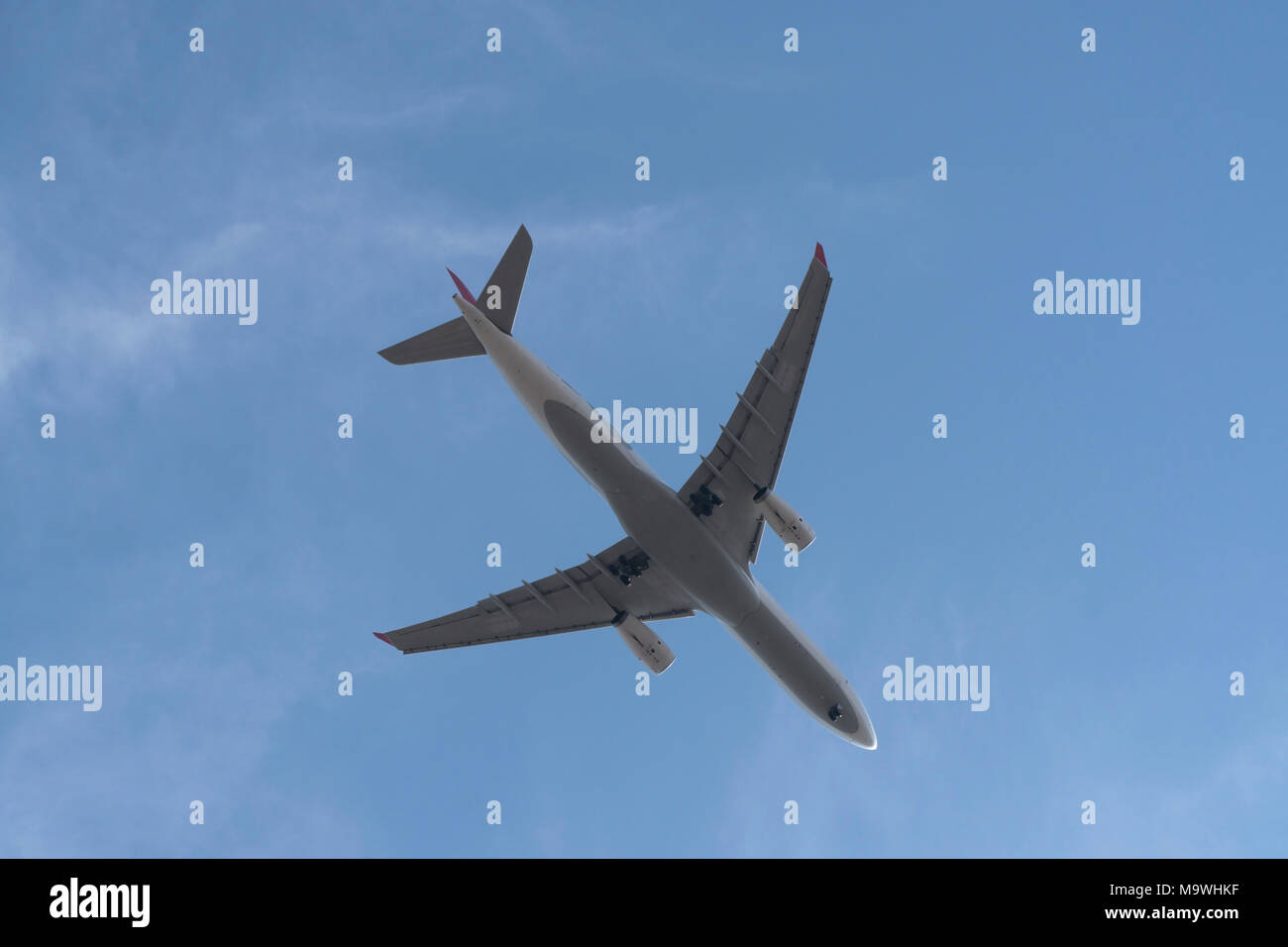 Passenger airplane at the sky from directly below Stock Photo