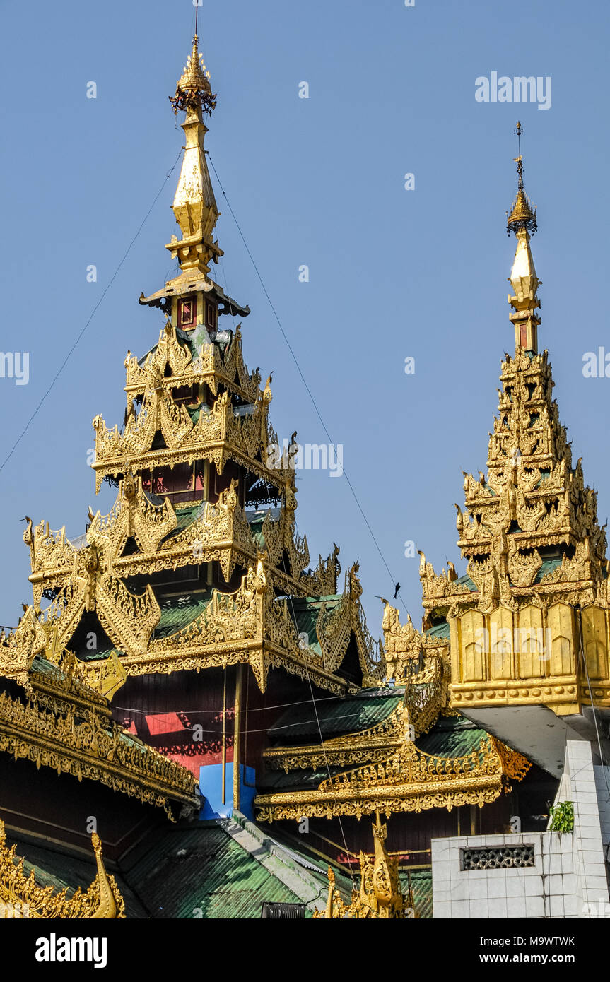 the elegant stupa of Sule Pagoda in front of the skyscrapers of downtown Yangon Stock Photo