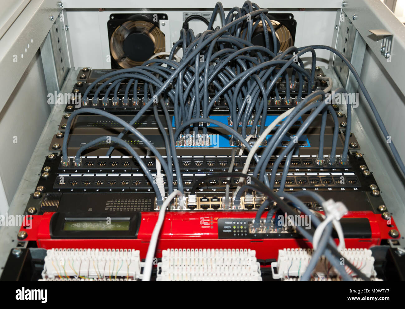 Network cables and servers in a technology data center Stock Photo