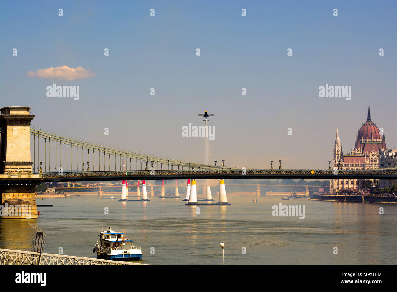 Air show in Budapest. Airplane soars up above Danube river and Chain bridge Stock Photo