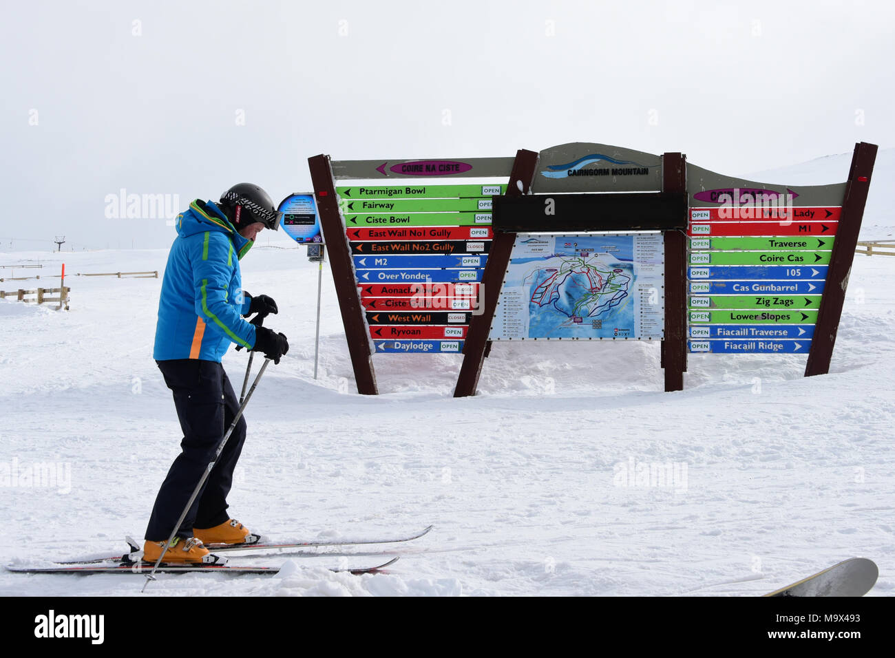 Aviemore, Scotland, United Kingdom, 28, March, 2018. A skier passes an indicator board and piste map at Cairngorm Mountain ski centre, © Ken Jack / Alamy Live News Stock Photo