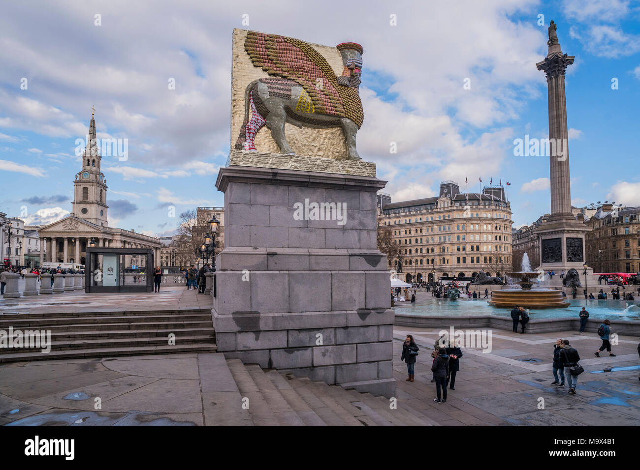 London, UK. 28th March, 2018. The Invisible Enemy Should Not Exist, the latest artwork for the fourth plinth at Trafalgar Square, by Artist Michael Rakowitz. It is designed as a tribute to “something good in the human spirit” and as a recreation of a statue destroyed by ISIS in 2015. The sculpture, which shows a mythical winged beast called a Lamassu, is 4.5 metres high, took four months to build and is made up of 10,500 empty Iraqi date syrup cans symbolising one of the country’s former thriving industries shattered by war. Credit: Guy Bell/Alamy Live News Stock Photo