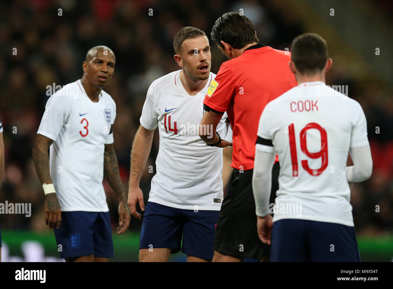 London, UK. 27th March 2018. Jordan Henderson of England argues with referee Deniz Aytekin after the official had reviewed the VAR to award Italy a penalty. Football International friendly, England v Italy at Wembley Stadium in London on Tuesday 27th March 2018.  Editorial Use Only pic by Andrew Orchard/Alamy Live news Stock Photo