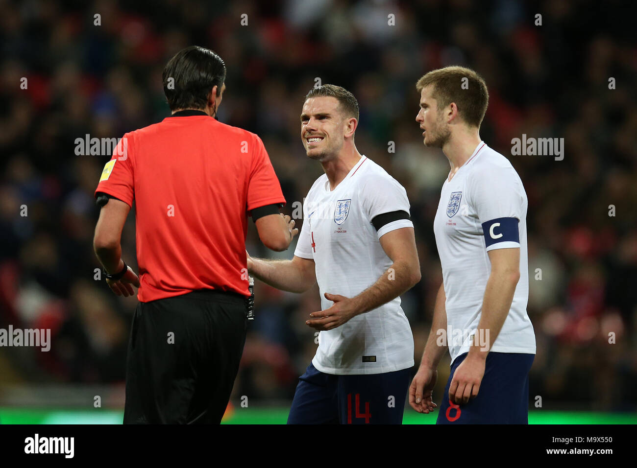 London, UK. 27th March 2018. Jordan Henderson of England (c) argues with referee Deniz Aytekin after the official had reviewed the VAR to award Italy a penalty. Football International friendly, England v Italy at Wembley Stadium in London on Tuesday 27th March 2018.  Editorial Use Only pic by Andrew Orchard/Alamy Live news Stock Photo