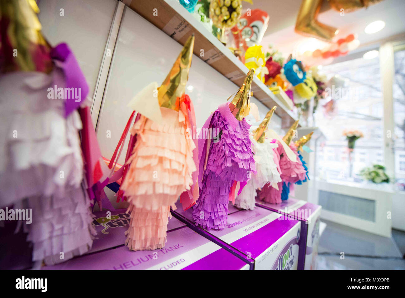 26 March 2018, Germany, Berlin: Pinatas on offer in a decoration shop.  Pinatas are papier mâché toy figures filled with candy and are  traditionally hung during children parties in Latin America and