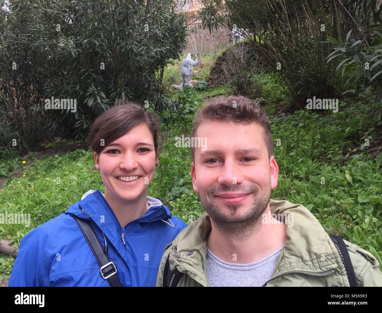 28 March 2018, Italy, Rome: Tourist Danny Drath from Schwerin and his companion Juliane Berndt standing in an area in front of the colloseum that is being cleaned by prisoners. Romes decline is legendary. But now prisoners have been put to the task of making the messy city look spick and span. Tourists such as Danny think the the project is good. Photo: Annette Reuther/dpa Stock Photo