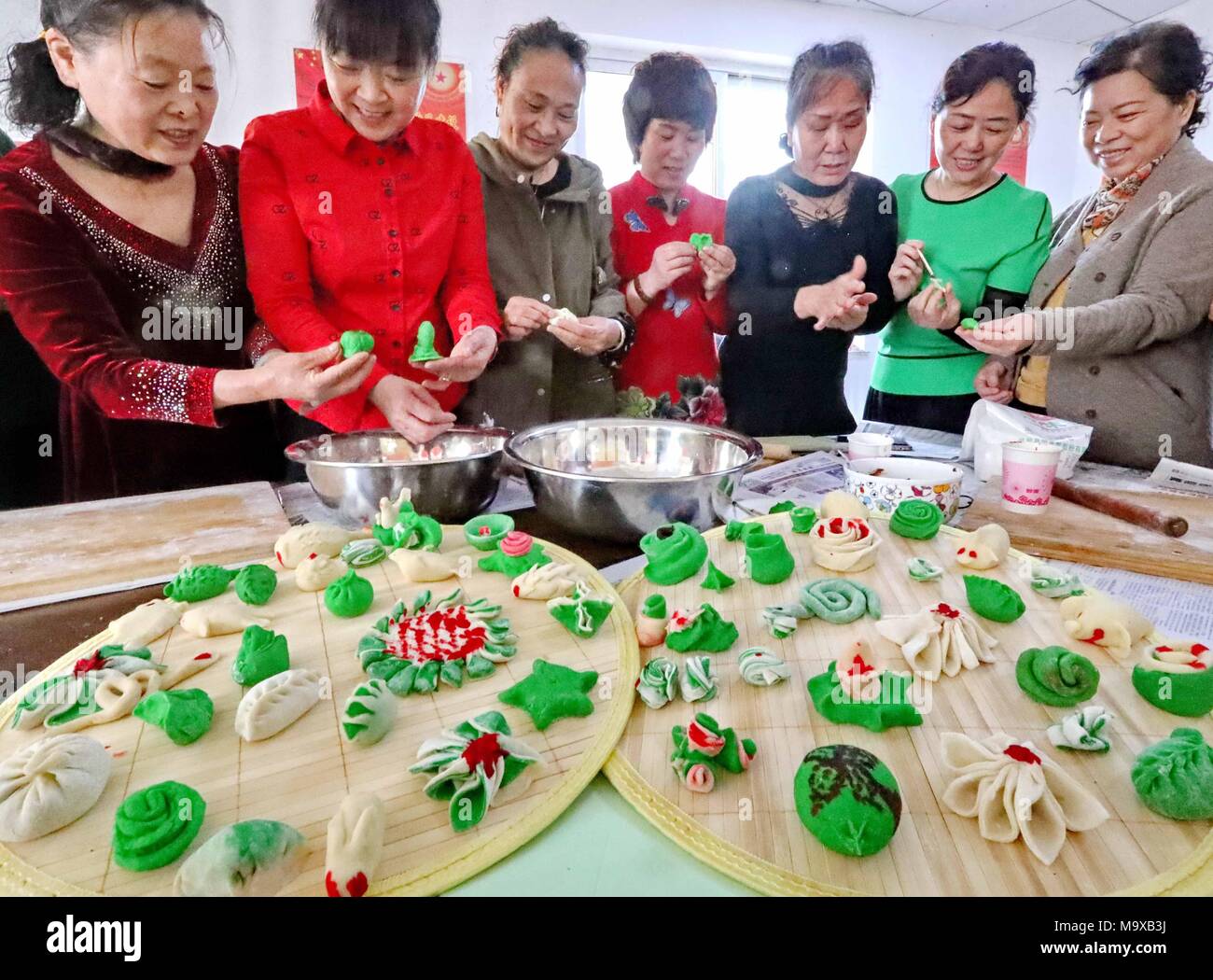 Qinhuangdao, Qinhuangdao, China. 29th Mar, 2018. Qinhuangdao, CHINA-29th March 2018: People make traditional food to celebrate Cold Food Festival in Qinhuangdao, north China's Hebei Province. The Cold Food or Hanshi Festival is a traditional Chinese holiday which developed from the local commemoration of the death of the Jin nobleman Jie Zhitui in the 7th century BC under the Zhou into an East Asian occasion for the commemoration and veneration of ancestors by the 7th-century Tang. The lighting of fire was avoided, even for the preparation of food. This practice originally occurred at midwint Stock Photo