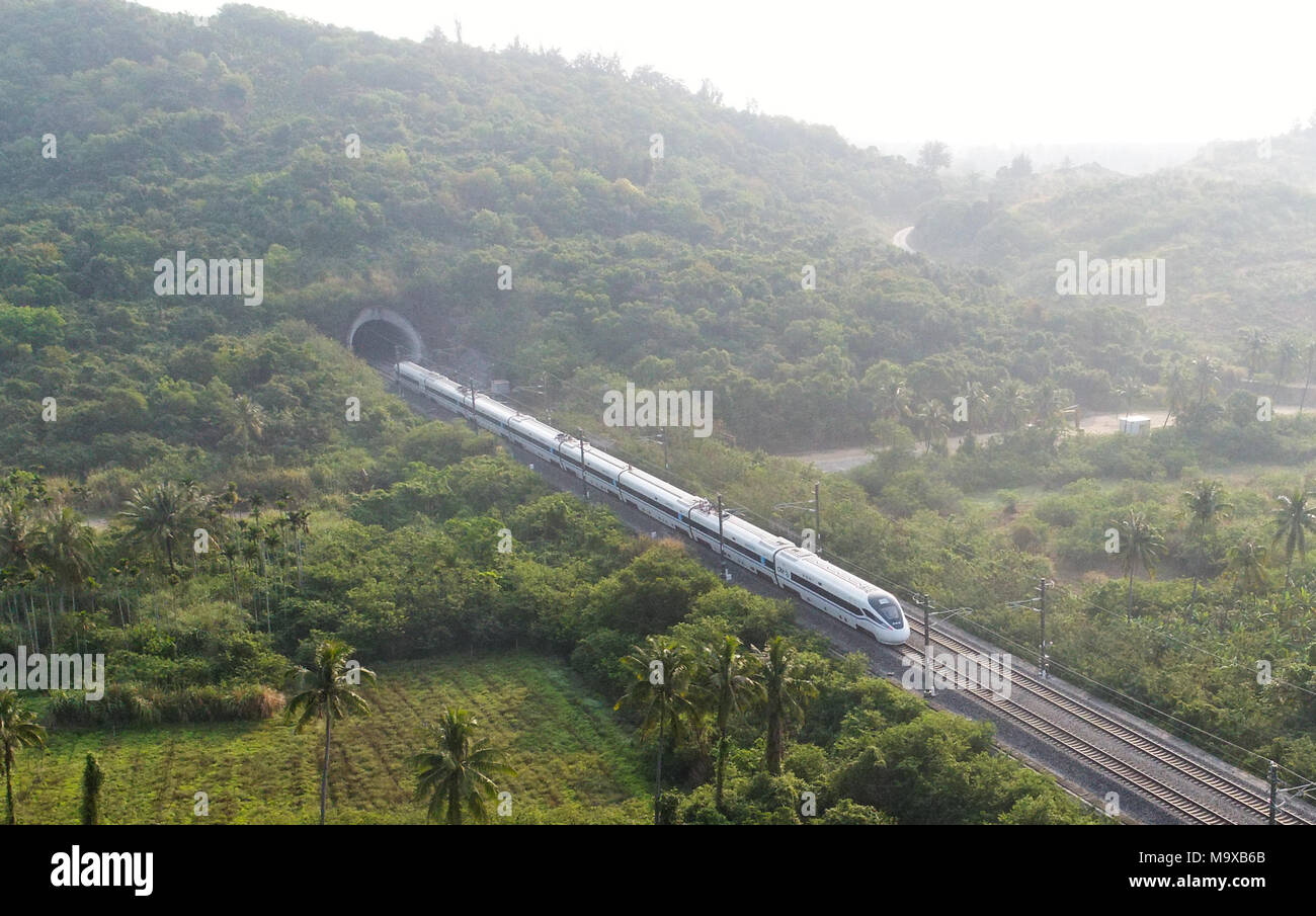 Haikou. 16th Mar, 2018. Photo taken on March 16, 2018 shows a bullet train running on the eastern track of the high-speed loop line near Wanning Railway Station, south China's Hainan Province. The 653-km high-speed railway line circling the island received over 25 million passengers in 2017. Credit: Yang Guanyu/Xinhua/Alamy Live News Stock Photo