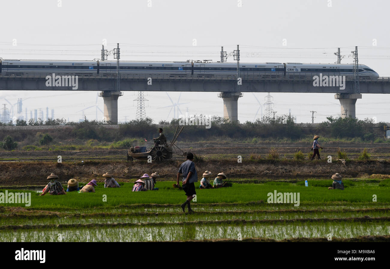 Haikou. 7th Mar, 2018. Photo taken on March 7, 2018 shows a bullet train running on the western track of the high-speed loop line near Dongfang Railway Station, south China's Hainan Province. The 653-km high-speed railway line circling the island received over 25 million passengers in 2017. Credit: Yang Guanyu/Xinhua/Alamy Live News Stock Photo