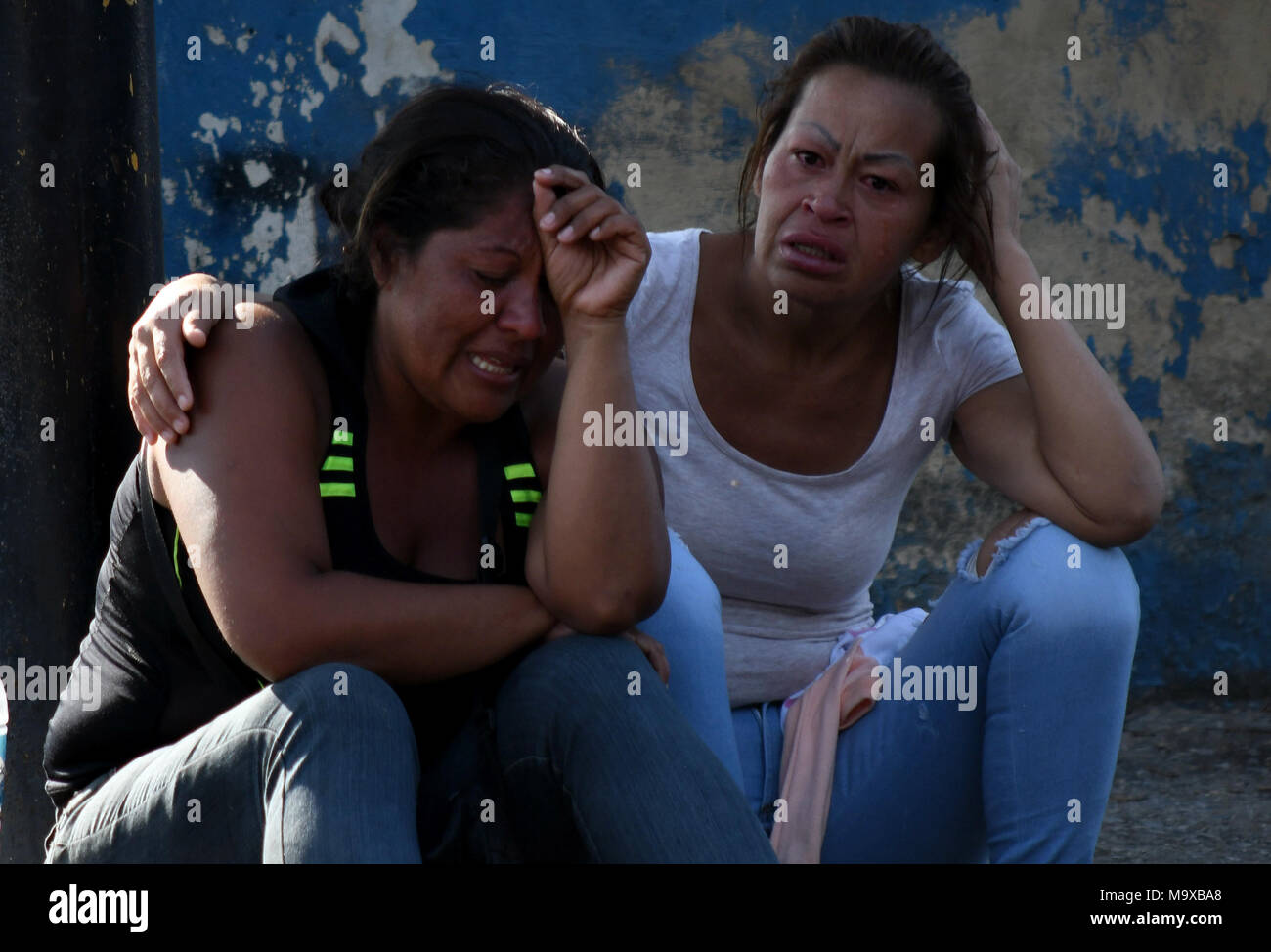 Carabobo, Venezuela. 28th Mar, 2018. Relatives react as they wait for information after an alleged fire at a Venezuelan police station, in Valencia, Carabobo state, Venezuela, on March 28, 2018. A prison riot and fire has broken out at a Venezuelan police station in the central city of Valencia and at least 68 people were killed, Venezuelan officials said Wednesday. Credit: Roman Camacho/SOPA/ZUMAPRESS/Xinhua/Alamy Live News Stock Photo