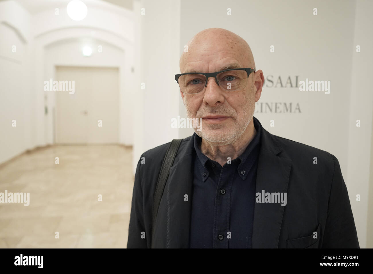29 March 2018, Germany, Berlin: Musician and sound artist Brian Eno during the presentation of the installation 'Empty Formalism' in the Martin Gropius Building. The installation displays colourful and continuously changing surfaces on canvas while spherical sounds play. The work is part of the exhibition 'ISM Hexadome'. Photo: Jörg Carstensen/dpa Stock Photo