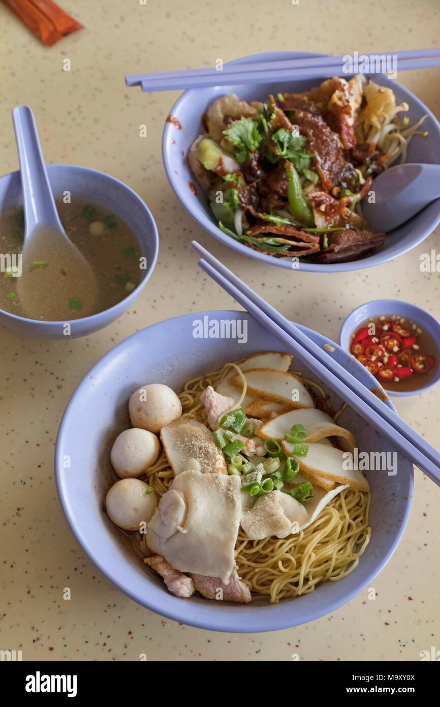 Asian family eating fast food Tiong Bahru Market Singapore Stock Photo