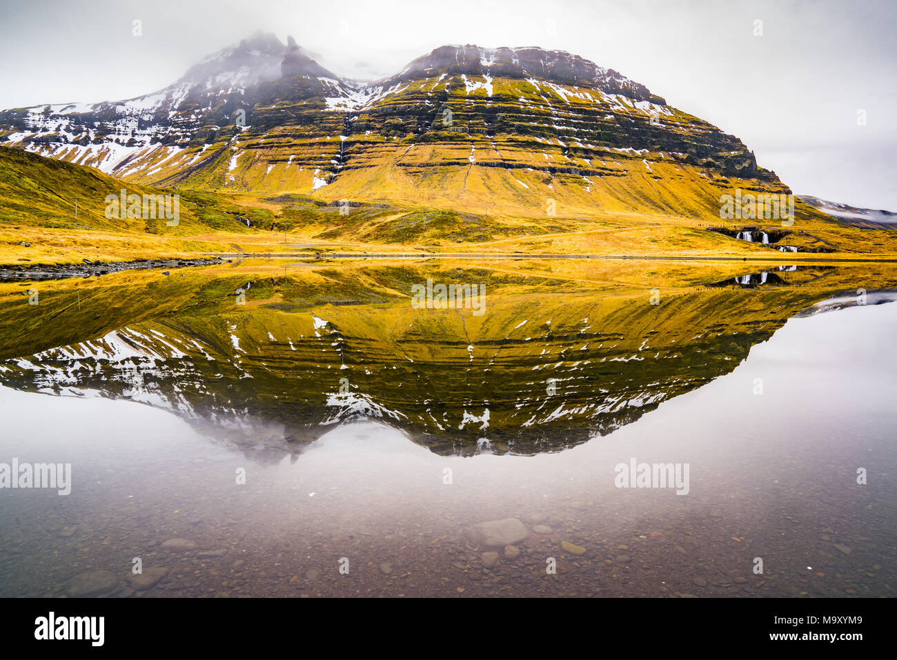 Reflection on lake near Kirkjufellsfoss, one of the most iconic waterfalls along the Snaefellsness peninsula of Iceland Stock Photo