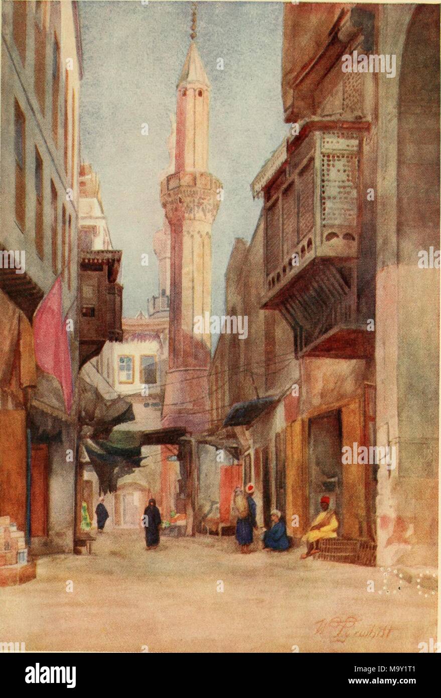 Color illustration depicting Fatimid-era architecture in the street of Al-Azhar in old Cairo, Egypt, with several human figures, sitting and walking in the foreground, overhanging porticos built from mashrabiyya on the second levels of buildings at right and left, and the minaret of a mosque in the background, from the volume 'Cairo, Jerusalem, and Damascus, ' authored by David Samuel Margoliouth, and illustrated by Walter Spencer-Stanhope Tyrwhitt, 1912. Courtesy Internet Archive. () Stock Photo