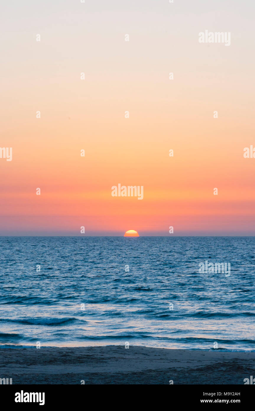 Sunset sun going down to the sea Stock Photo Alamy