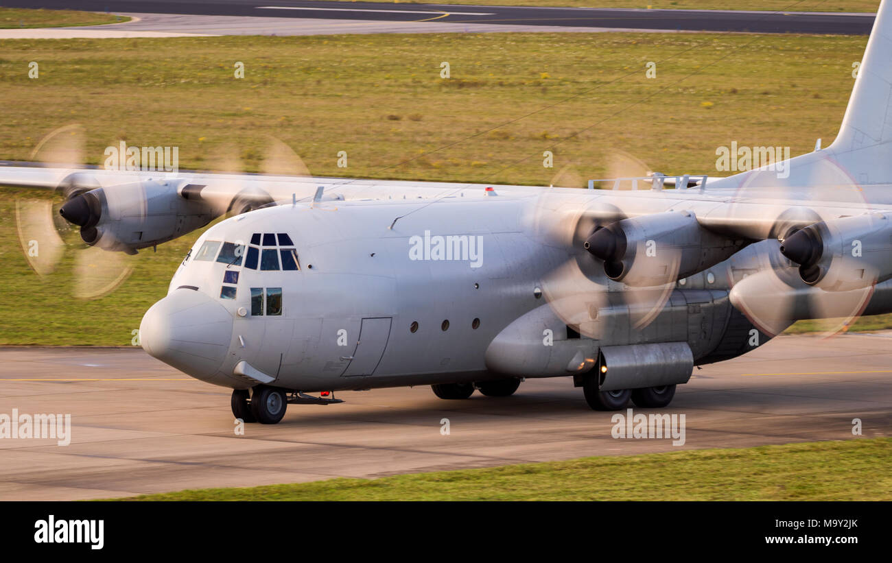 Military cargo airplane with turboprop engine motion blur taxiing. Stock Photo
