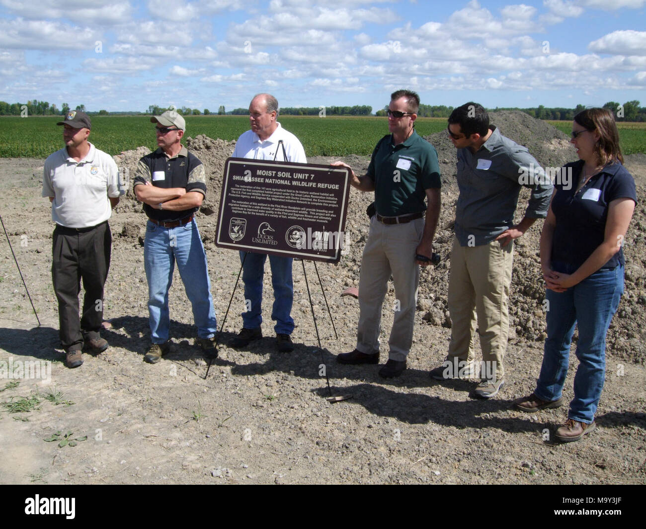 From left to right, Steve Kahl, Russ Terry, Charlie Wooley, Michael Kelly, Chris Adamo, and Barb Avers stand next to a sign to be placed at Shiawassee National Wildlife Refuge Moist Soil Unit 7, once finished. Stock Photo