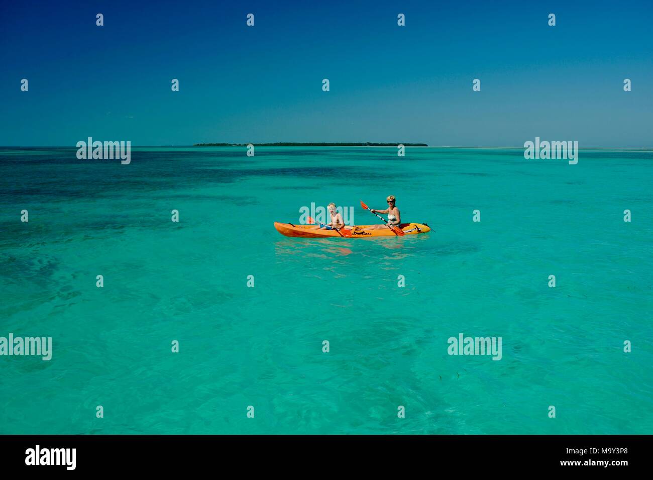 Mother and son kayaking in pristine, warm ocean water off Key West