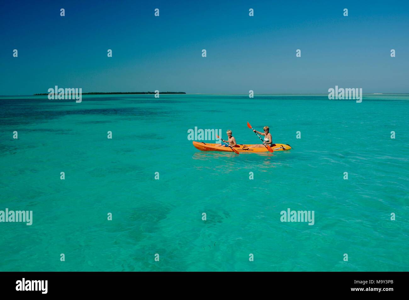 Mother and son kayaking in pristine, warm ocean water off Key West