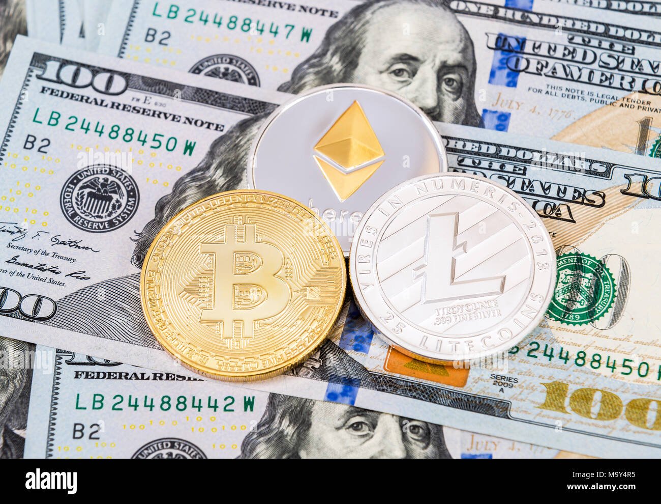 Digital cryptocurrency Bitcoin, Ethereum and Litecoin lying on the one  hundred american dollar bills. Business concept of new virtual money Stock  Photo - Alamy