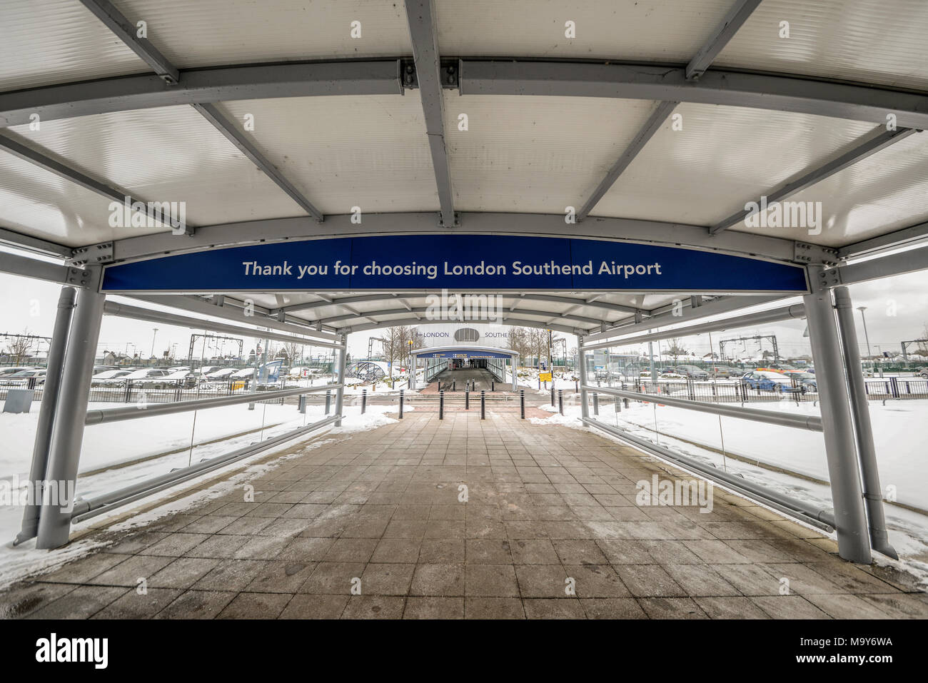 Covered walkway to London Southend Airport railway station from the airport terminal. Snow on the ground Stock Photo