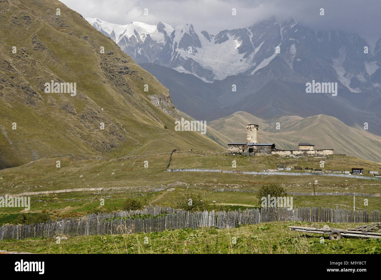 A medieval tower house sits at the foot of the Caucasus Mountains, Ushguli, Upper Svaneti, Georgia Stock Photo
