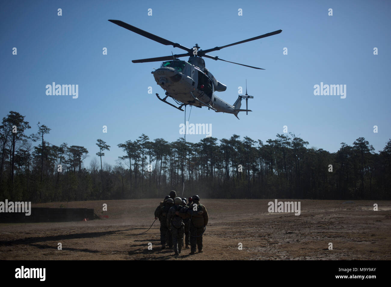 U.S. Marines with II Marine Expeditionary Force Information Group prepare to take off during special patrol insertion and extraction operations training at Camp Lejeune, N.C., March 23, 2018. The Marines conducted the training to improve operational capabilities and to recertify helicopter rope suspension techniques masters from across II MEF. (U.S. Marine Corps photo by Pfc. Larisa Chavez) Stock Photo