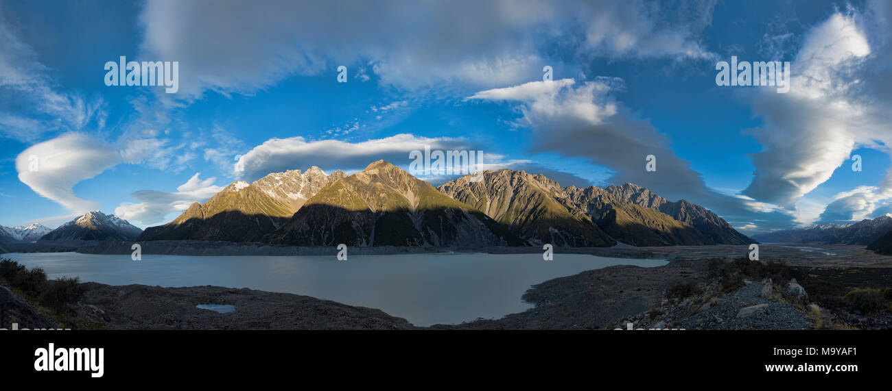 Wild lenticular clouds sail over Lake Tasman and the Southern Alps, New Zealand Stock Photo