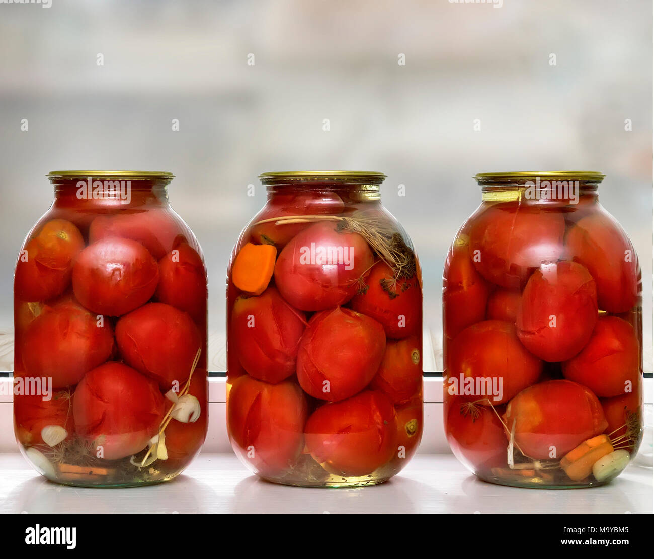 Glass jars with red ripe tomatoes, sealed airtight metal lid Stock Photo Alamy