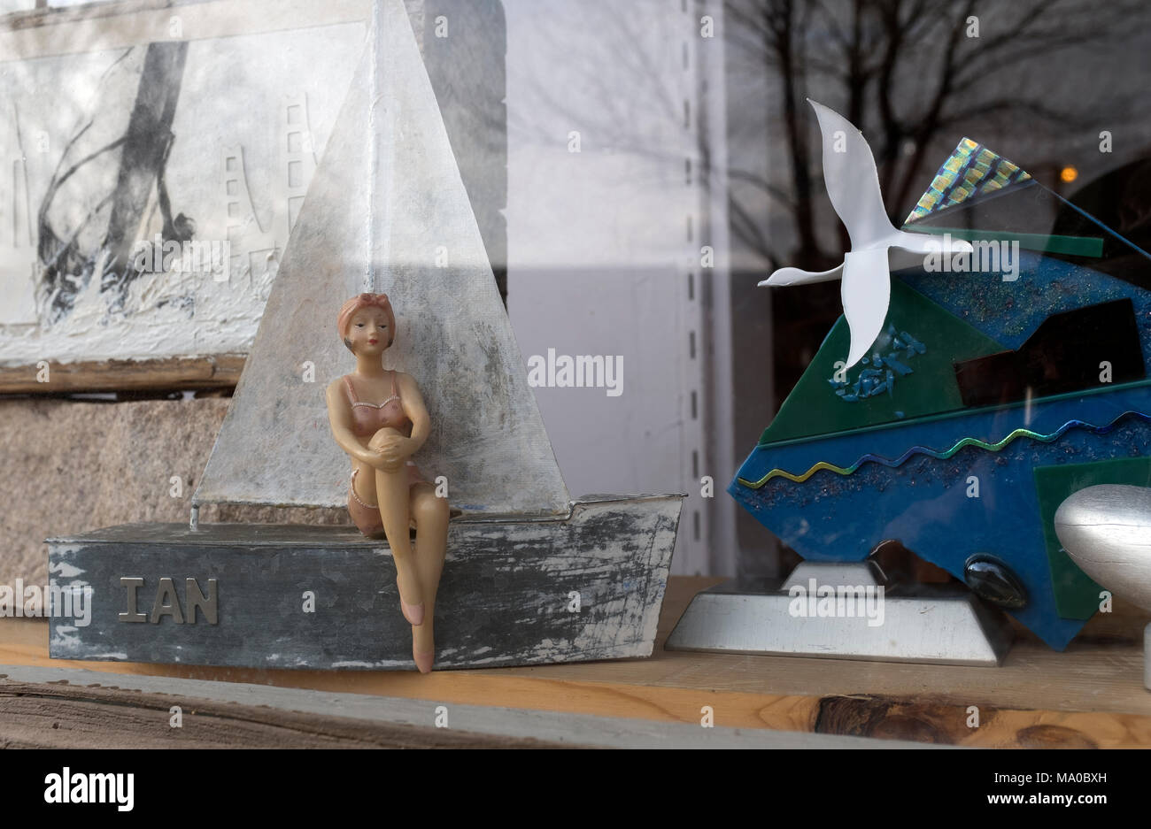 window diorama of woman sitting on boat and other objects Stock Photo