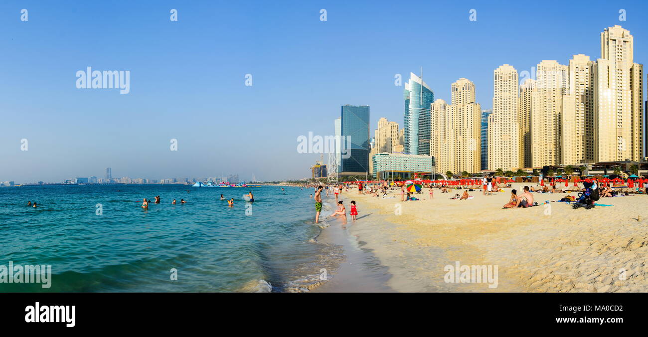 Dubai, United Arab Emirates - March 8, 2018: JBR, Jumeirah Beach Resort panoramic view with many swimmers and visitors on a sunny day in Dubai, United Stock Photo