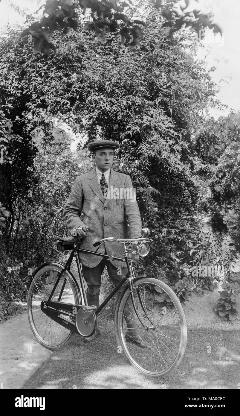 A young man in late Victorian England, standing with a new bicycle and dressed in very good quality leisure wear of the time. Stock Photo