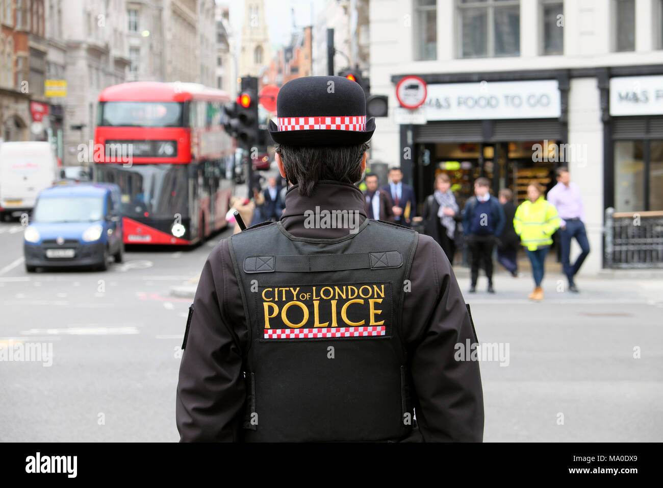 City of London Police logo on back of uniform jacket of policewoman (police woman) on the street in Farringdon area of Central London UK  KATHY DEWITT Stock Photo