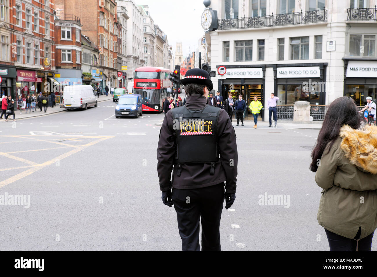 Rear view female policewoman City of London Police in uniform on the street in Central London England UK Great Britain   KATHY DEWITT Stock Photo