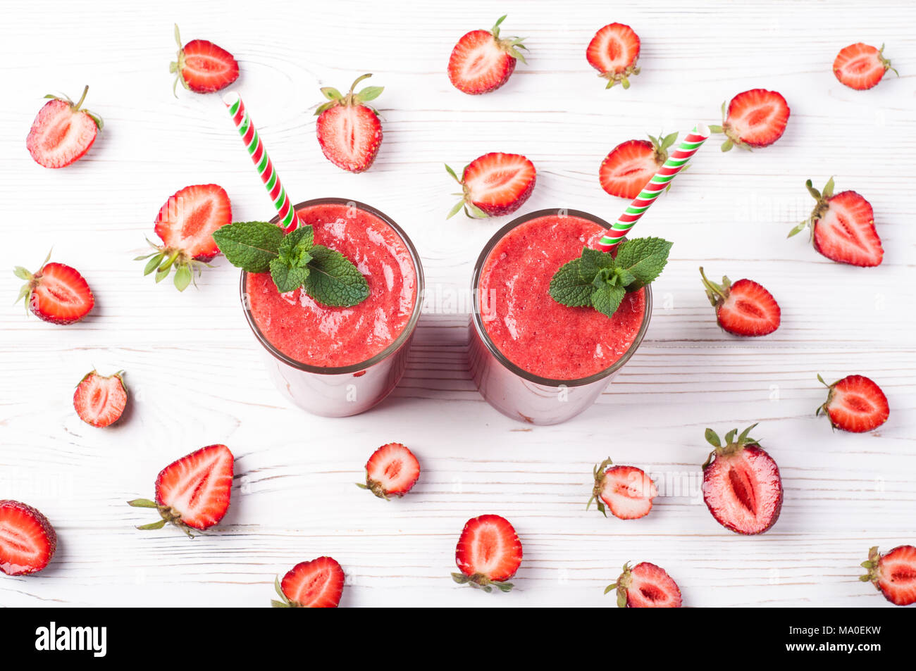 Strawberry smoothie in glass on white background. Summer drink cocktail. Healthy eating dieting and breakfast concept. Top view Stock Photo