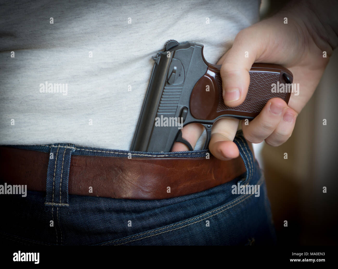 Man hiding gun behind his back Stock Photo Alamy