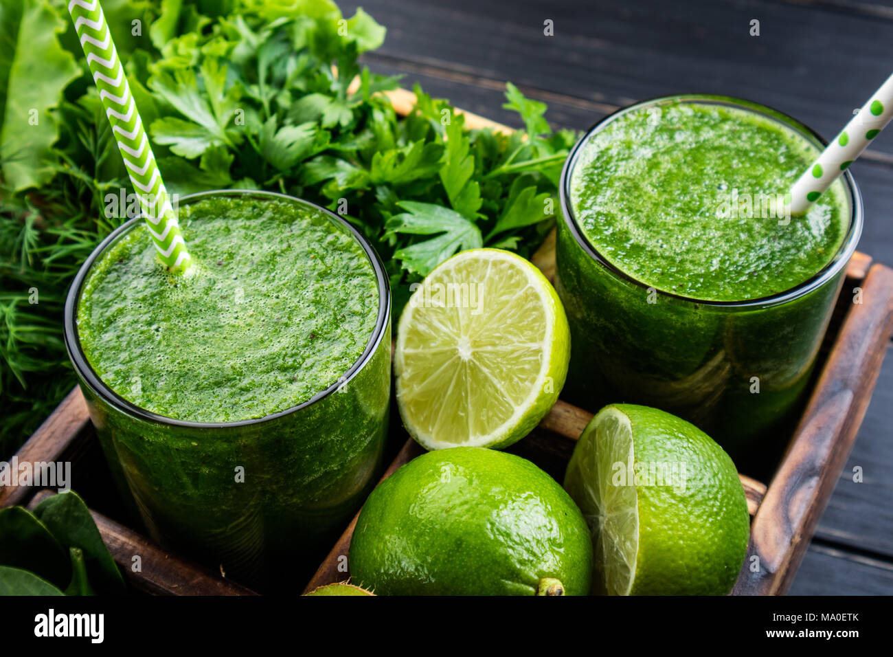 Green smoothie with vegetables, fruits and herbs. Healthy smoothie with spinach, lime, kiwi and herbs. Healthy drink and dieting concept. Closeup Stock Photo