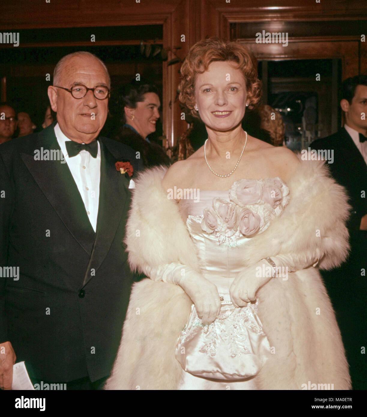 ANNA NEAGLE (1904-1986) English film actress with husband Herbert Wilcox at a London premiere about 1965 Stock Photo