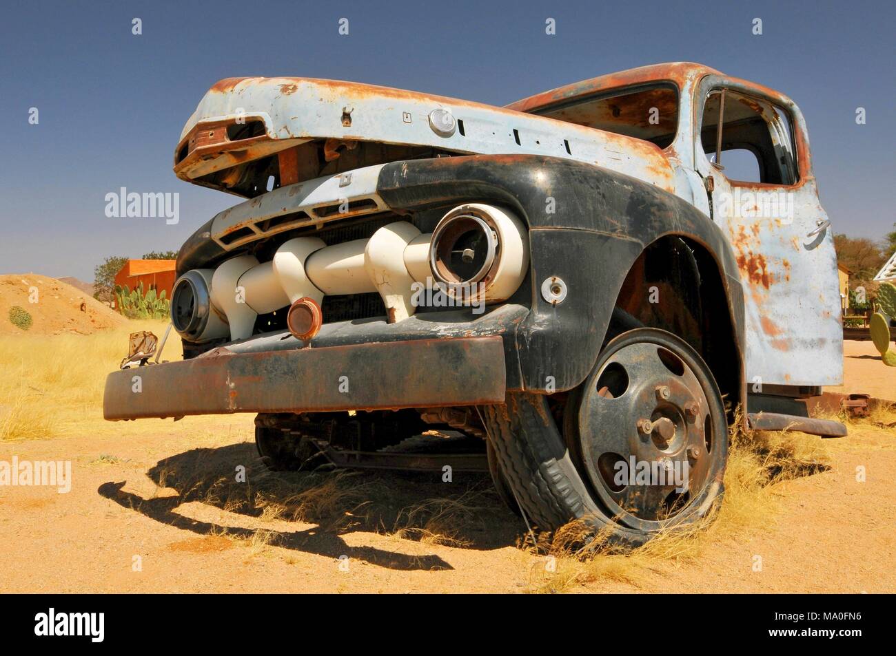 Old and rusty car wreck at the last gas station before the Namib desert ...