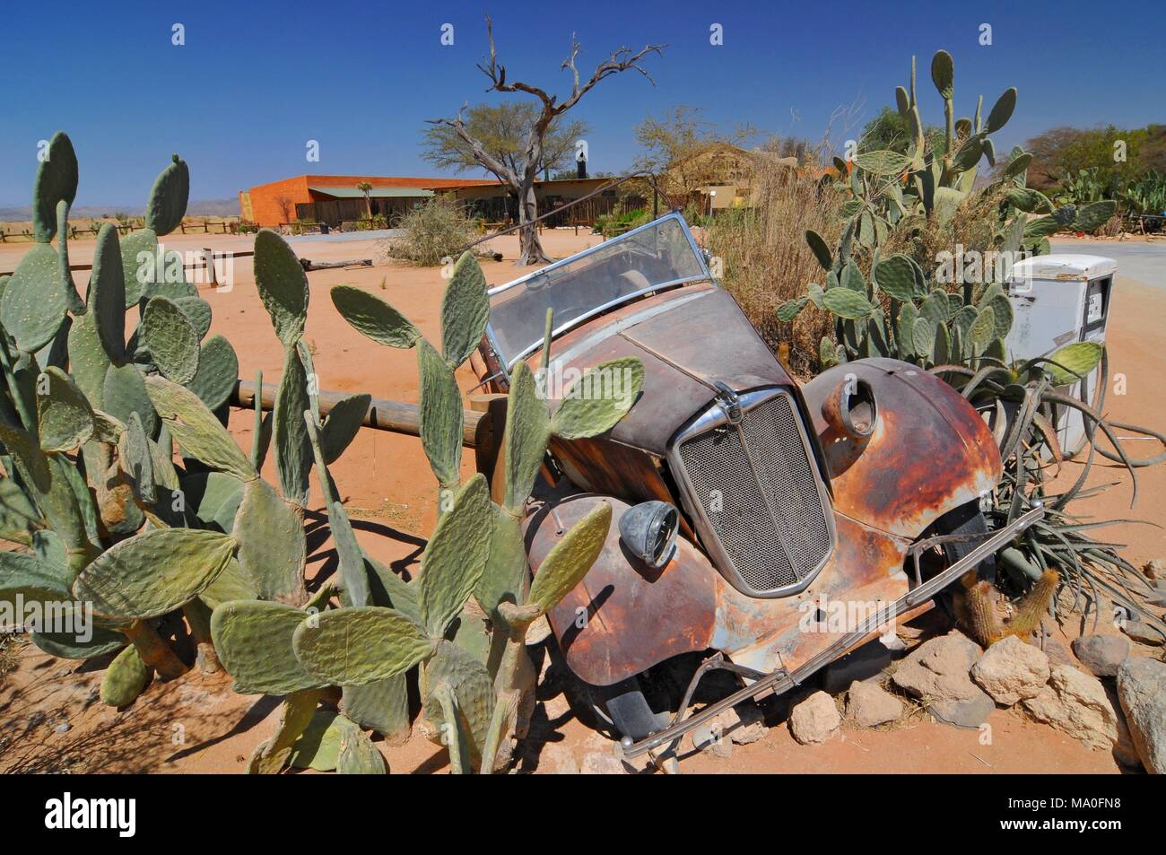 Old and rusty car wreck at the last gas station before the Namib desert ...