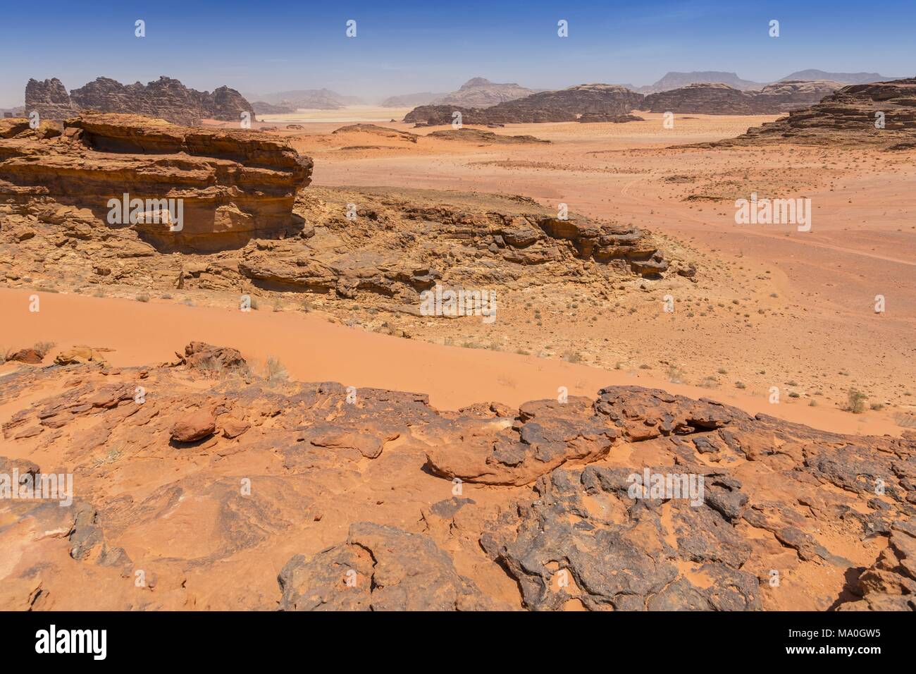 Reddish sand and rock landscapes in the desert of Wadi Rum, southern ...