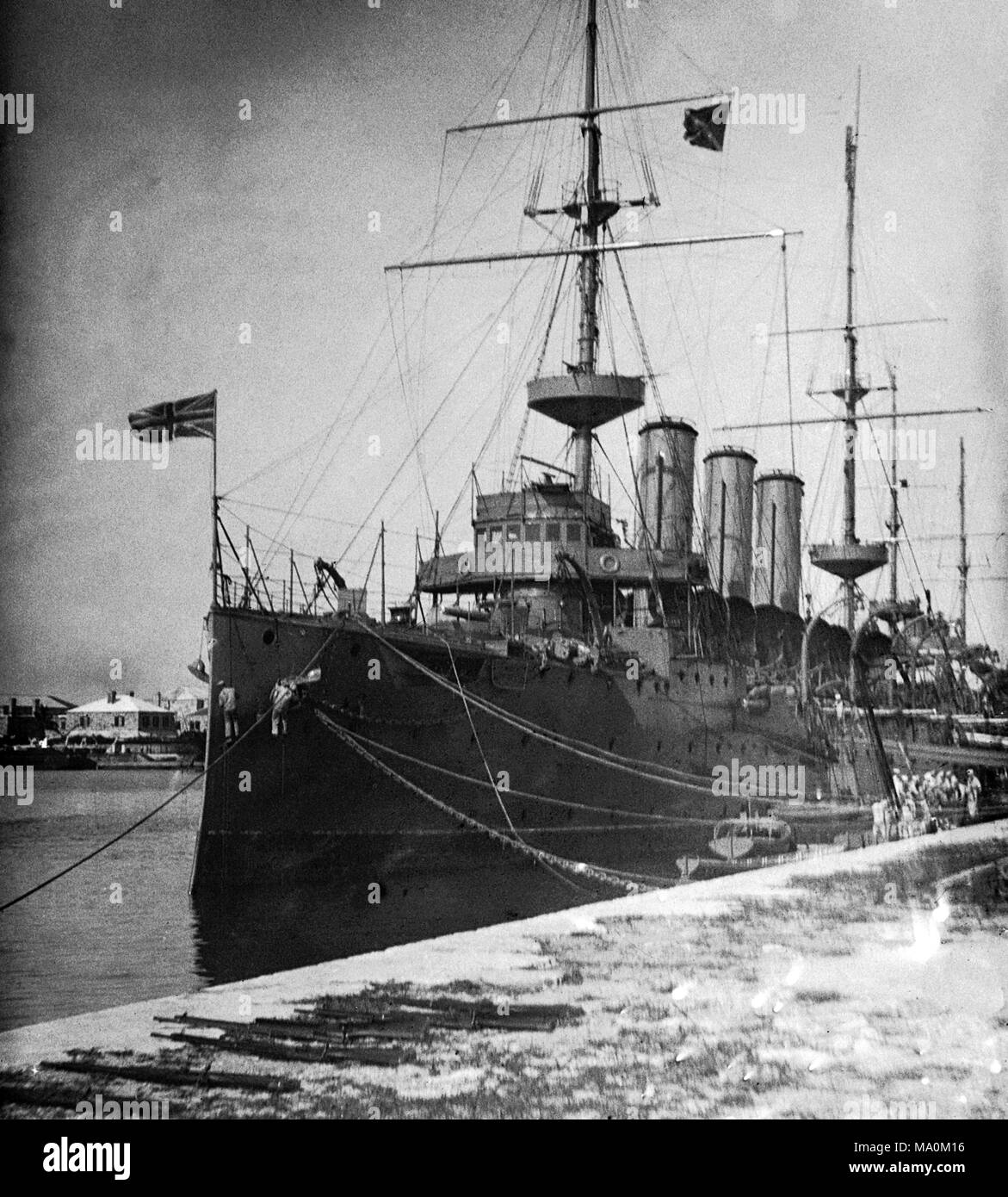 AJAXNETPHOTO. 1913 (APPROX). WEST INDIES STATION, BRMUDA. (POSSIBLY). BRITISH NAVAL ARMOURED CRUISER MOORED ALONGSIDE POSSIBLY ON THE WEST INDIES STATION. SHIP WAS A COUNTY CLASS ARMOURED CRUISER POSSIBLY HMS SUFFOLK. TWO CREW ON STAGING ARE PAINTING THE BOW OF THE SHIP. PHOTOGRAPHER:UNKNOWN © DIGITAL IMAGE COPYRIGHT AJAX VINTAGE PICTURE LIBRARY SOURCE: AJAX VINTAGE PICTURE LIBRARY COLLECTION REF:182303 BX4 06 Stock Photo