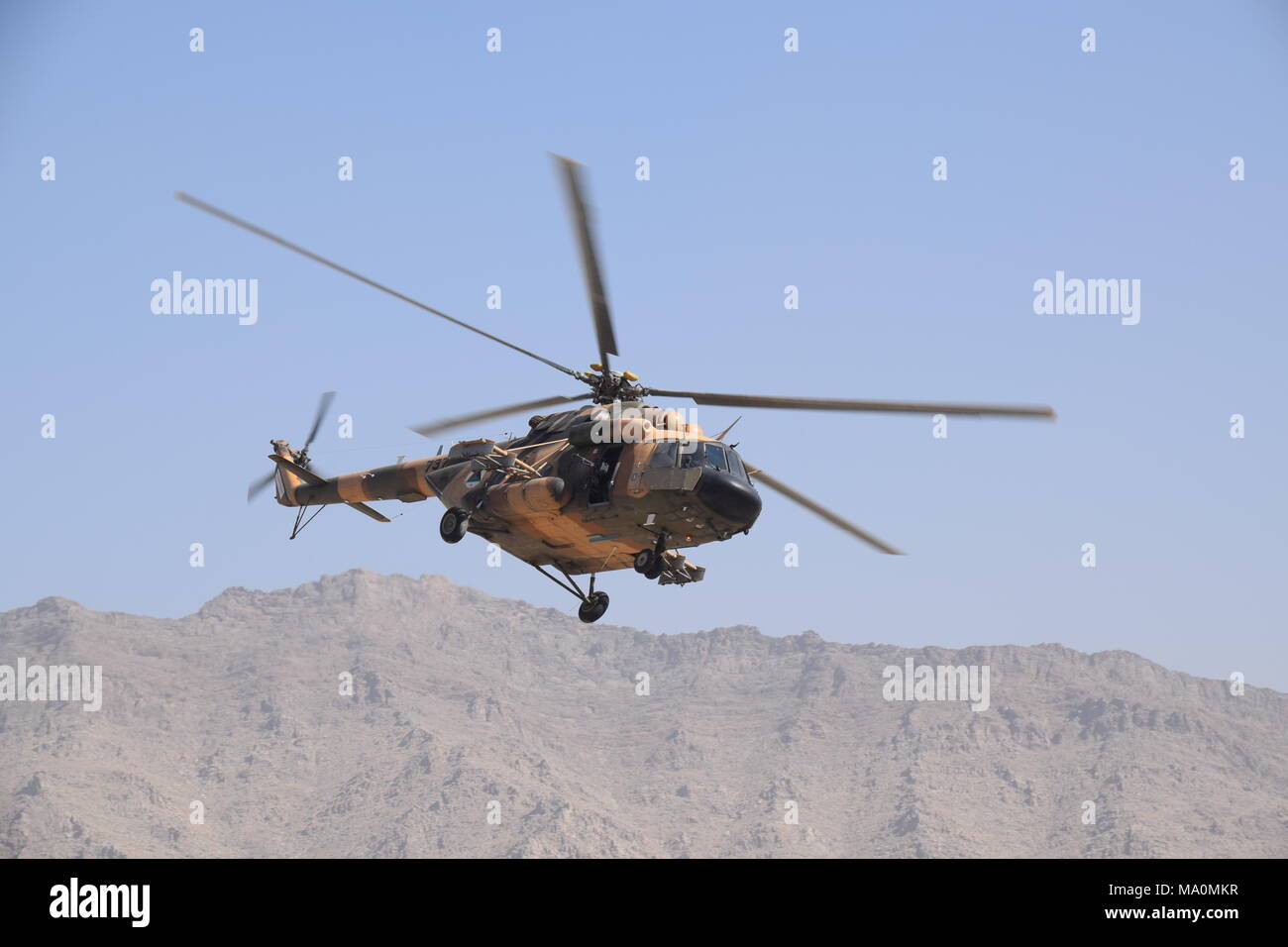 A Mi-17 transport helicopter of the Afghan Air Force flying in the sky over the Kabul Military Training Centre (KMTC), during an exercise. Stock Photo