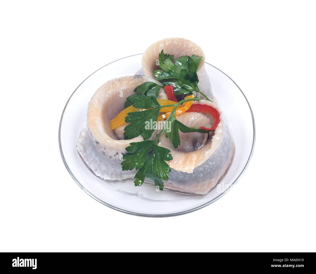 Matjes herring fillets in oil with parsley on clear plate isolated on