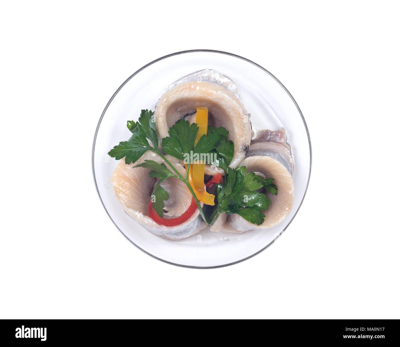 Matjes herring fillets in oil with parsley on clear plate isolated on