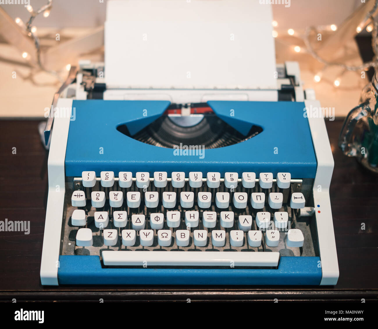Very Old Typing Machine, with blank white sheet and Greek Keyboard