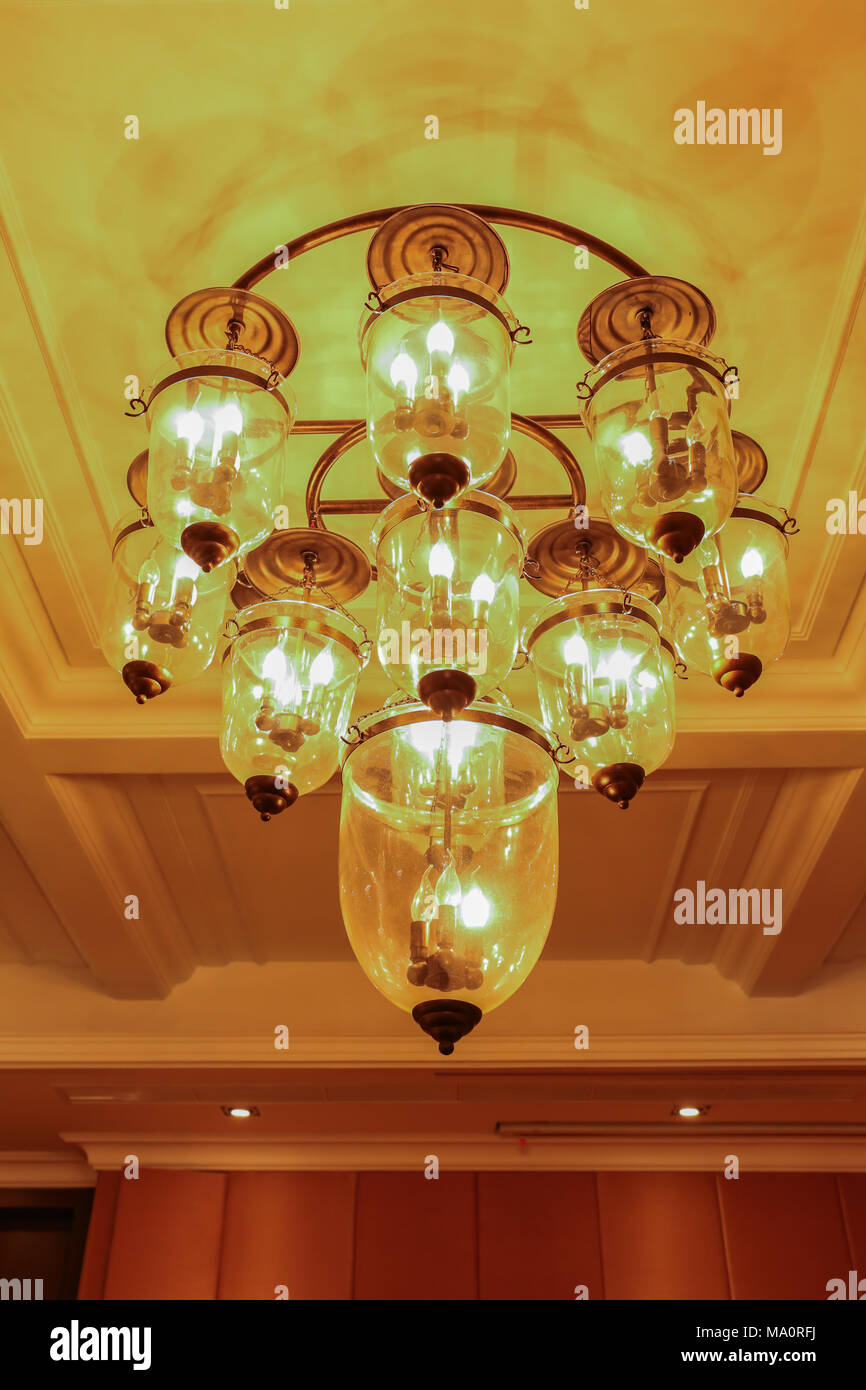 Yellow lamps with glass structure on ceiling in ballroom Stock Photo